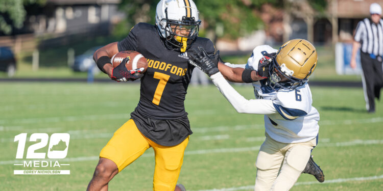Woodford County senior WR #7 Jalen Johnson stiff arms a Fairdale defender during the Fort Harrod Bowl at Alvis Johnson Field in Harrodsburg on August 23, 2025.