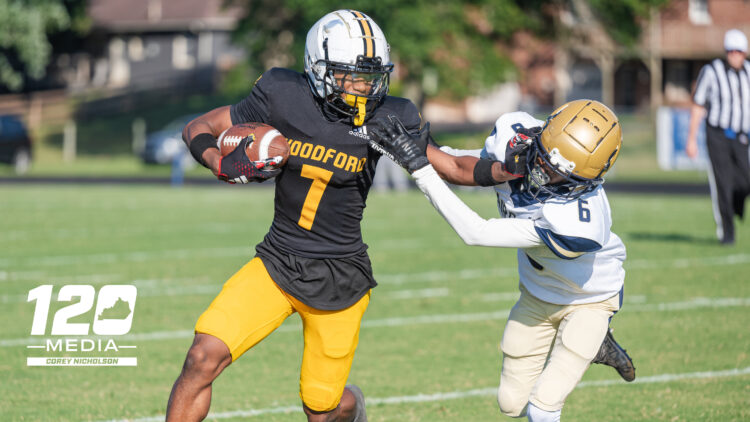 Woodford County senior WR #7 Jalen Johnson stiff arms a Fairdale defender during the Fort Harrod Bowl at Alvis Johnson Field in Harrodsburg on August 23, 2025.