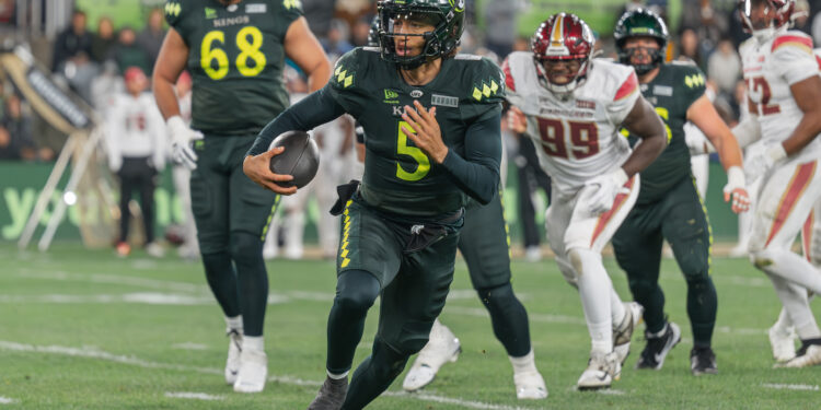 Louisville Kings quarterback Jason Bean (#5) scrambling for yardage against the Birmingham Stallions during the second quarter at Lynn Family Stadium